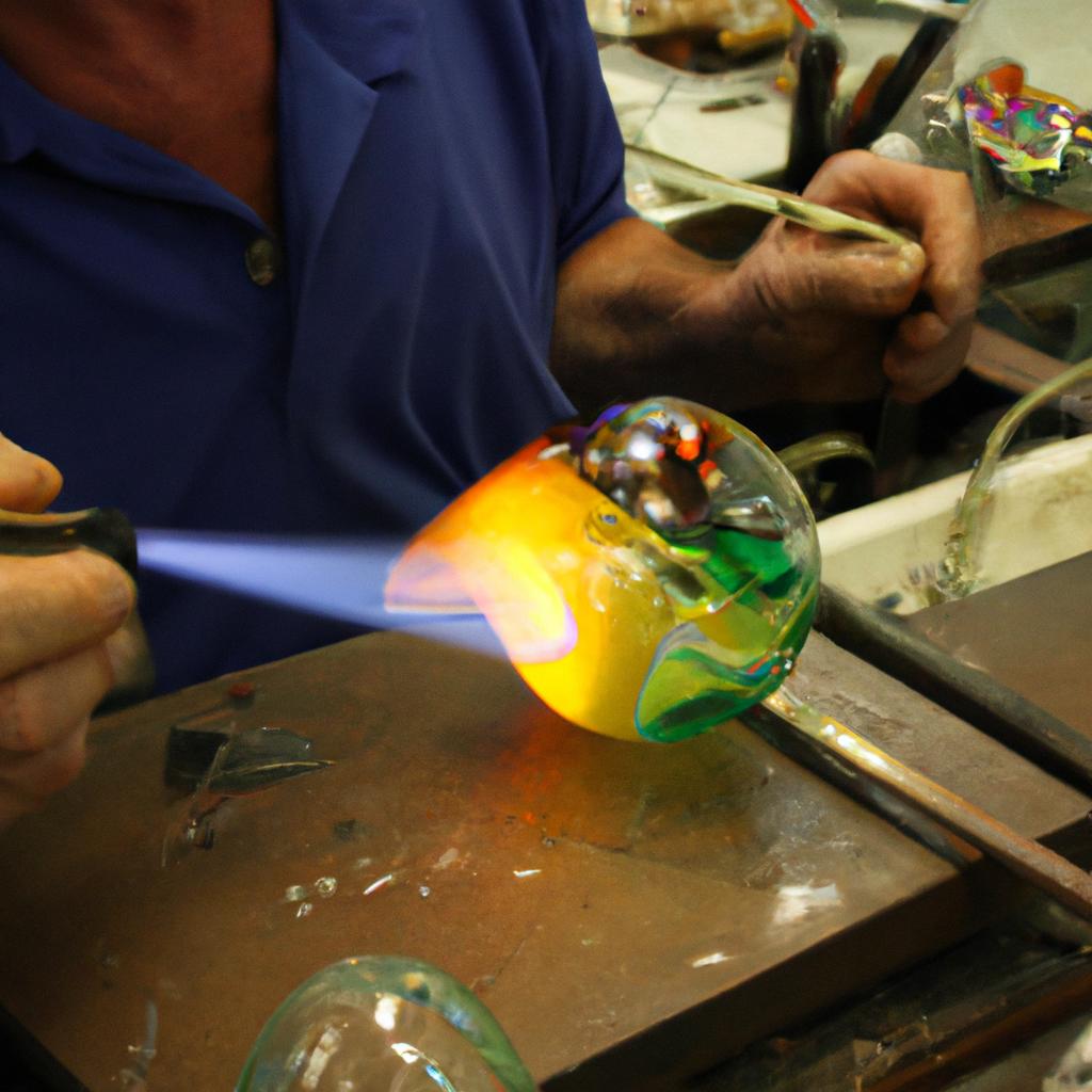 Person creating glass artwork